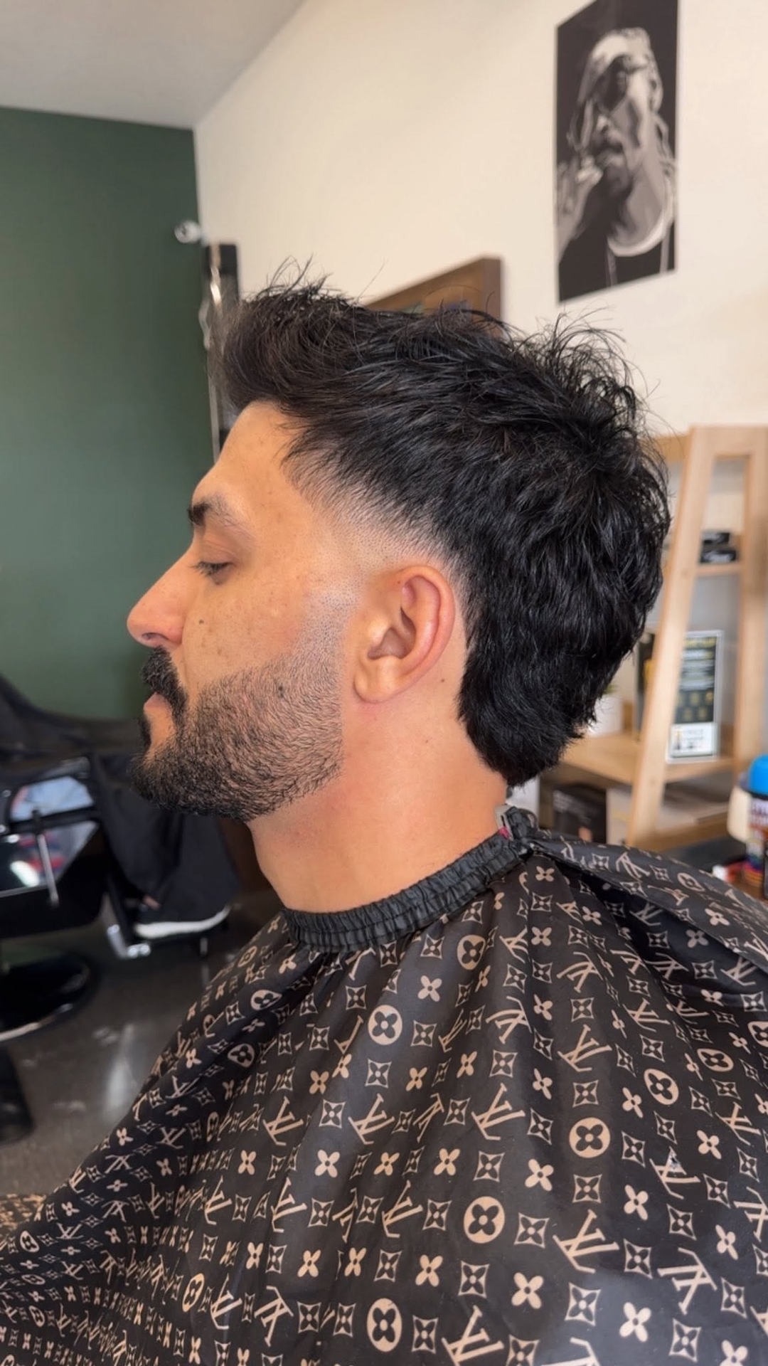 Client with a sharp fade and beard in the barbershop