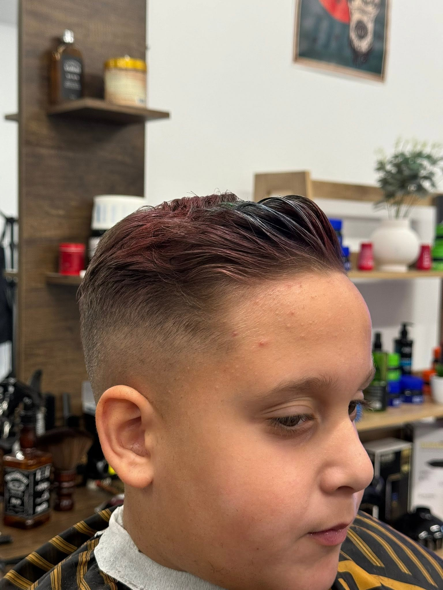Young client with a neat fade in the chair