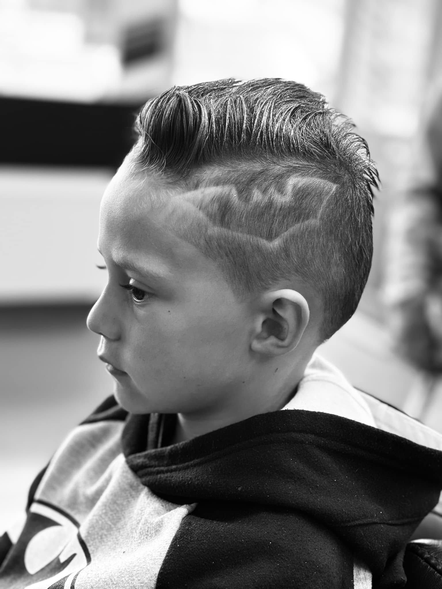 Boy with a hair-design fade, monochrome