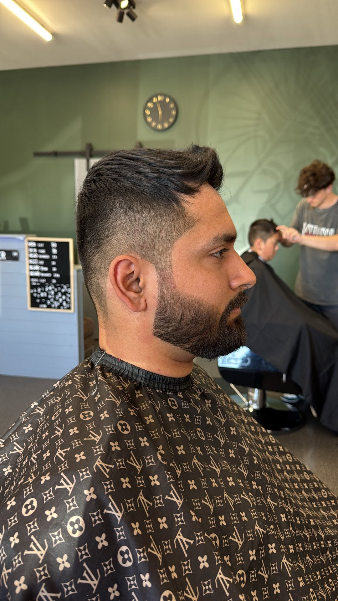 Client getting a fade, side profile in the chair